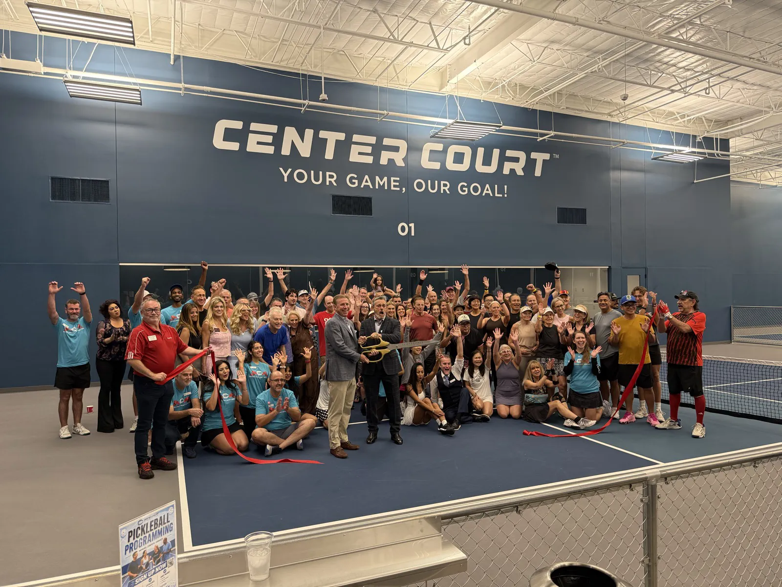 A crowd of pickleball players cheers after the ribbon is cut at Center Court Scottsdale Shea